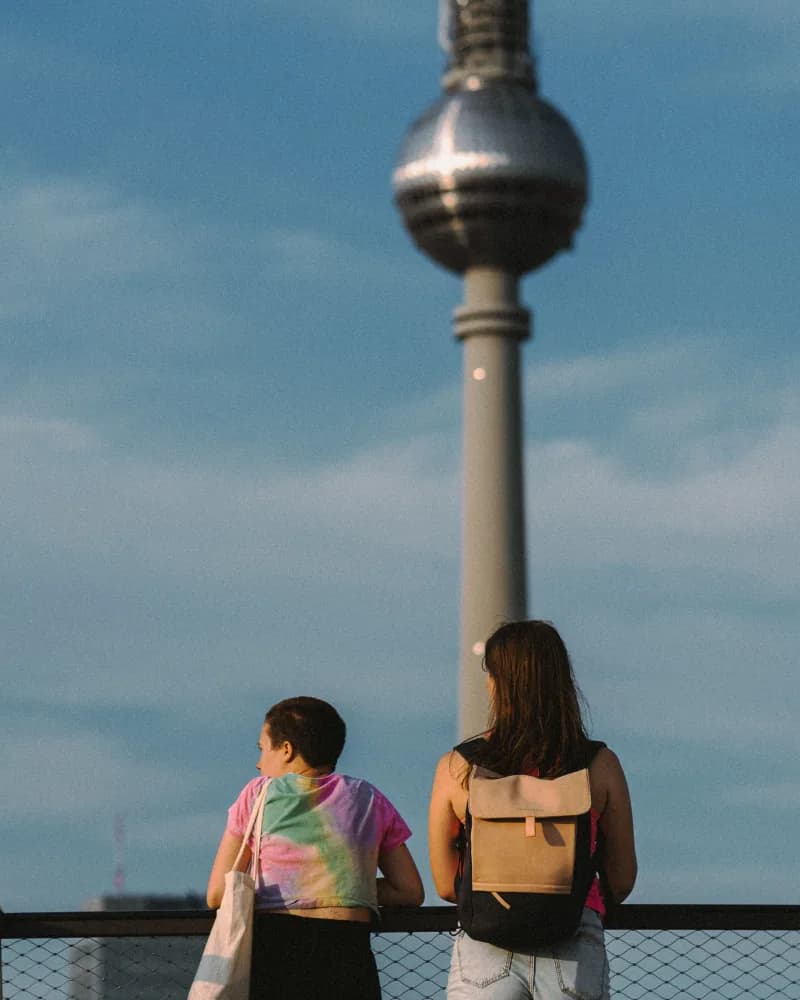Two travellers looking across Berlin towards the TV Tower